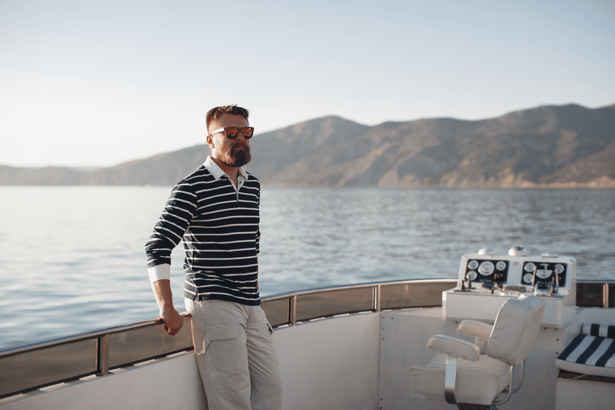 A boat owner on the helm of a yacht
