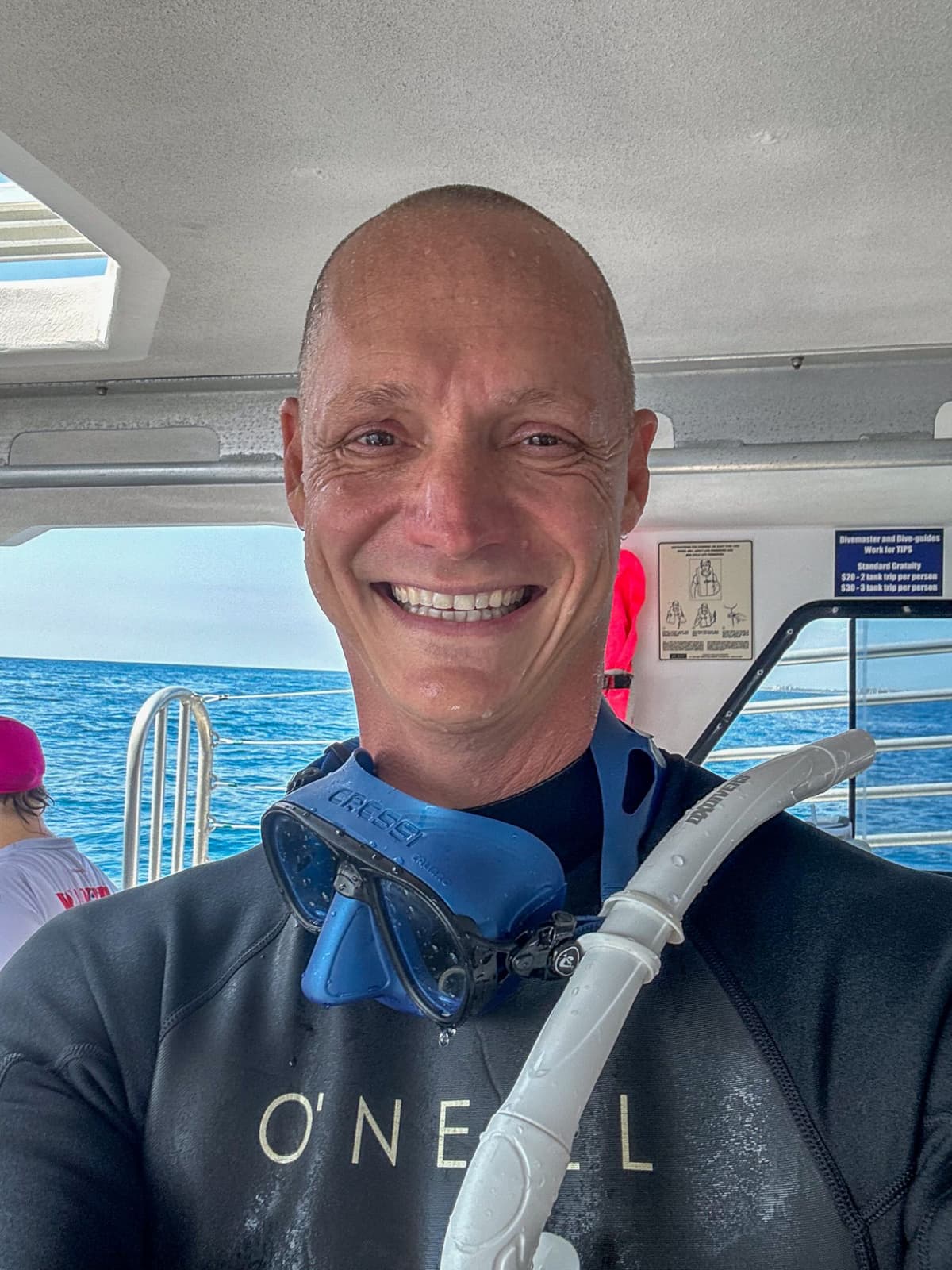 Jacob after a dive, mask and snorkel around his neck