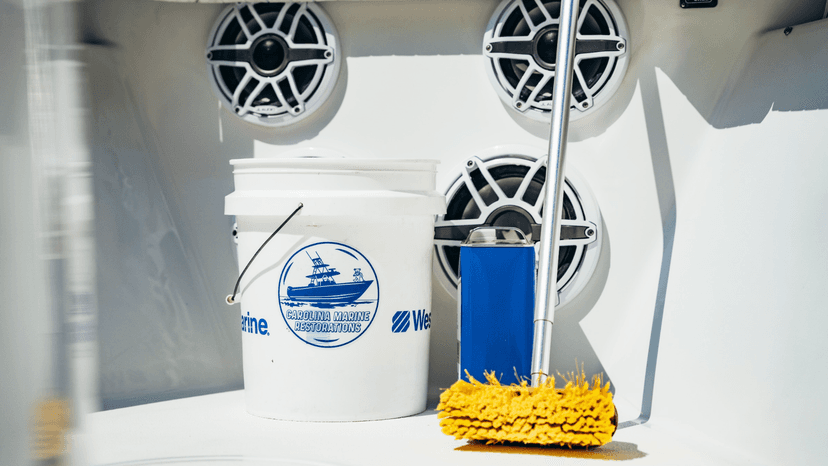 Bucket, brush and cleaning supplies on a boat deck at Carolina Marine Restorations, town not shown.